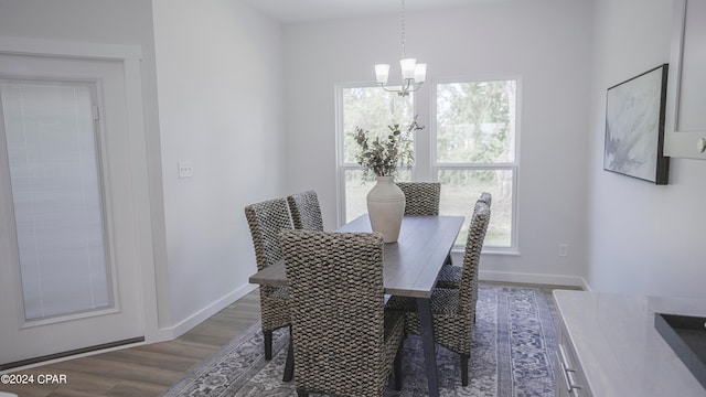 dining space with a chandelier and dark hardwood / wood-style floors