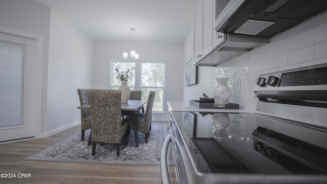 dining room featuring a notable chandelier and hardwood / wood-style flooring