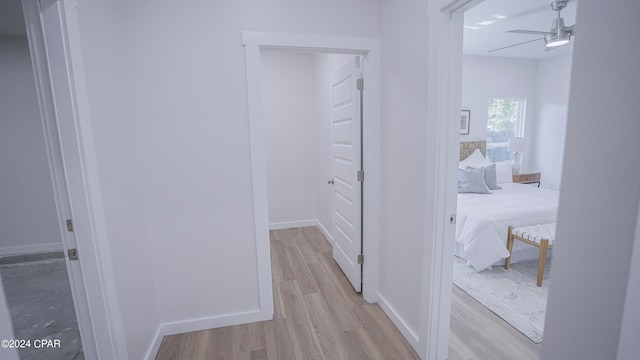 corridor with light hardwood / wood-style flooring