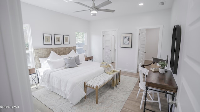 bedroom with ceiling fan and light hardwood / wood-style floors