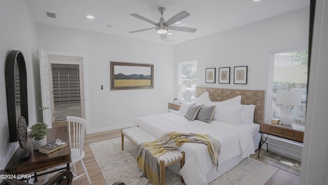 bedroom with light hardwood / wood-style flooring and ceiling fan