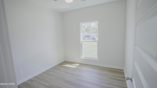 spare room featuring light hardwood / wood-style floors and ceiling fan