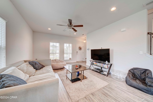 living room with wood-type flooring and ceiling fan