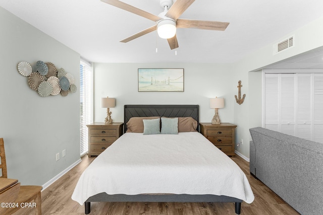 bedroom featuring ceiling fan, a closet, and light hardwood / wood-style flooring