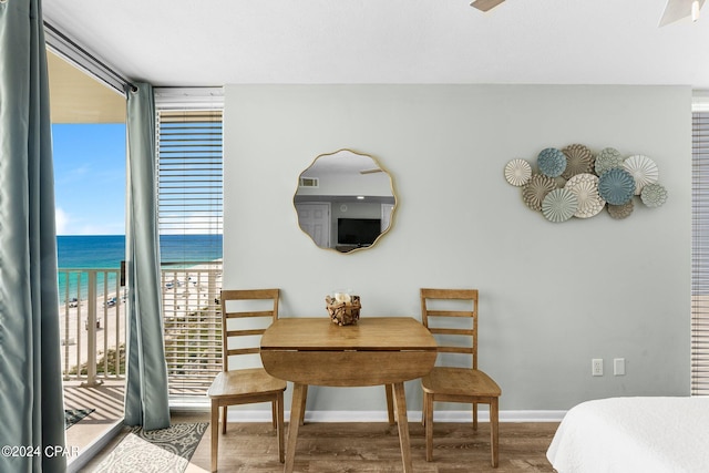 dining space with ceiling fan and hardwood / wood-style flooring