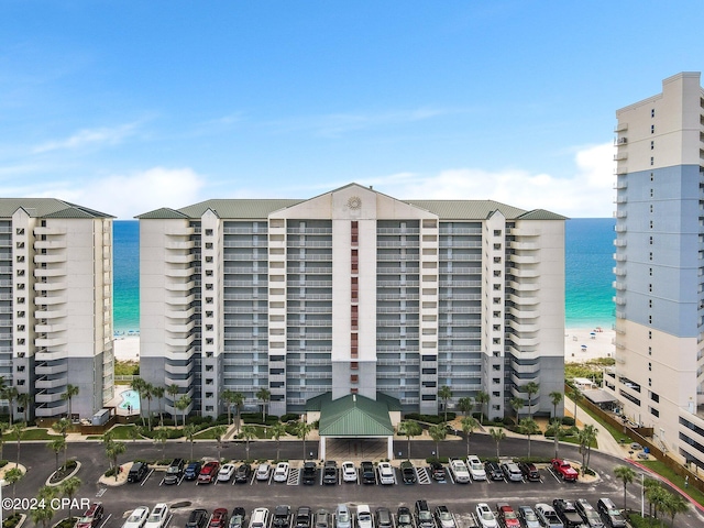 view of property with a beach view and a water view