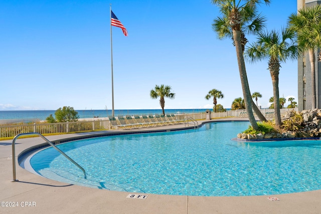 view of swimming pool featuring a water view