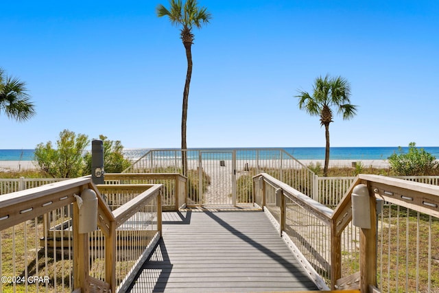 view of community with a water view and a beach view