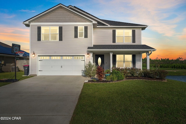 front facade with a lawn and a garage