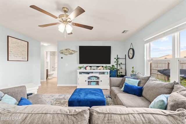 living room featuring ceiling fan and light wood-type flooring