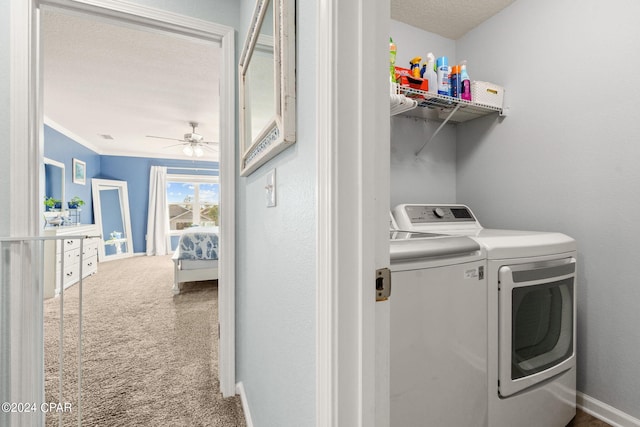 laundry area featuring a textured ceiling, carpet floors, independent washer and dryer, ornamental molding, and ceiling fan