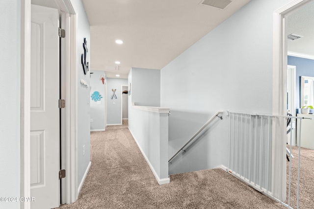 corridor featuring light colored carpet