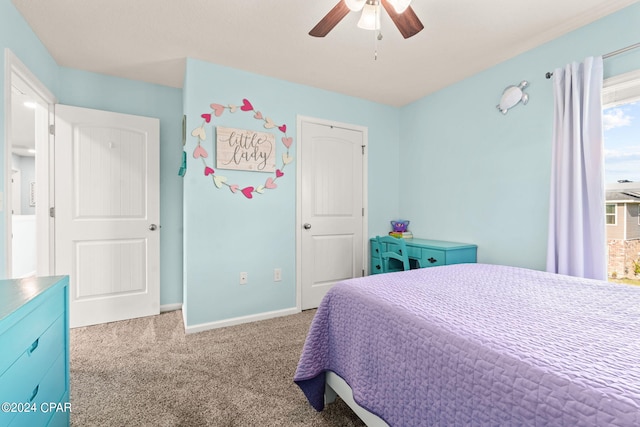 bedroom featuring ceiling fan and carpet