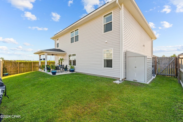 rear view of house featuring a lawn and a patio area