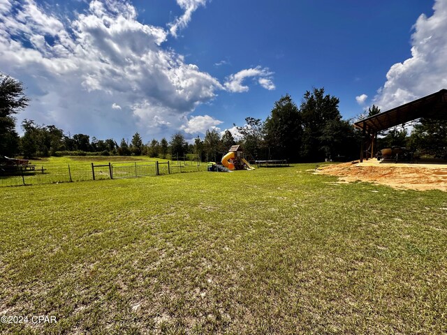 view of yard featuring a playground and a rural view