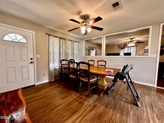 dining area featuring dark hardwood / wood-style flooring, ceiling fan, and a textured ceiling