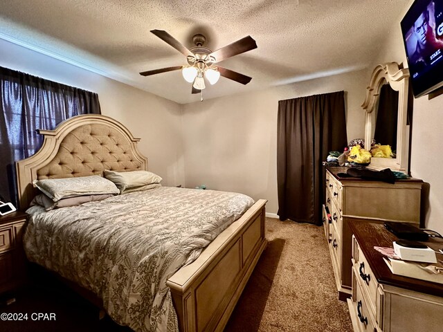 carpeted bedroom with a textured ceiling and ceiling fan