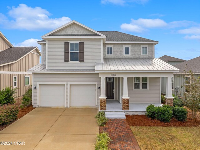 view of front of home featuring a porch and a garage