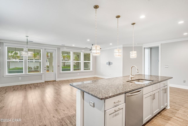 kitchen featuring sink, hanging light fixtures, dishwasher, light stone countertops, and white cabinets