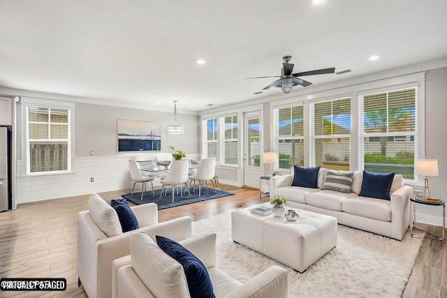 living room with ceiling fan and light hardwood / wood-style floors