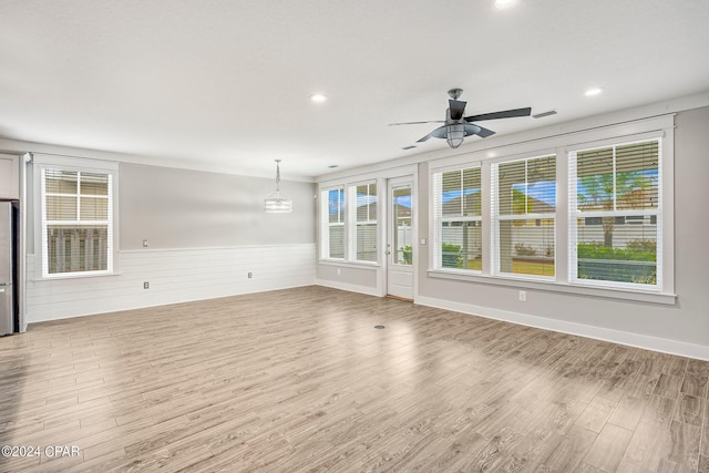 unfurnished living room with ceiling fan and light wood-type flooring