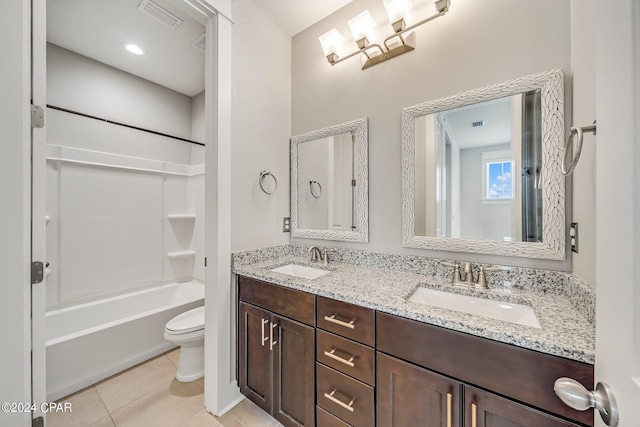 full bathroom with vanity, tile patterned floors, washtub / shower combination, and toilet