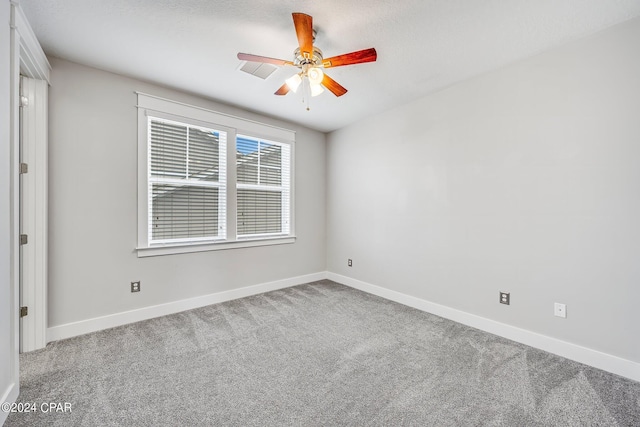 empty room with ceiling fan and carpet