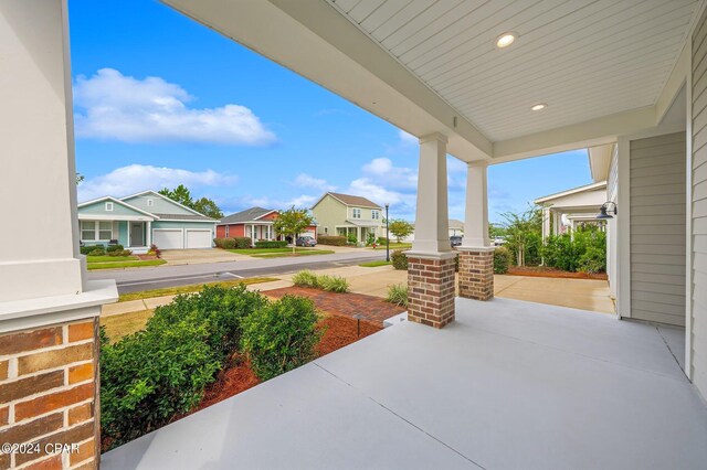 view of patio / terrace with a garage and a porch