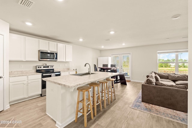 kitchen featuring light hardwood / wood-style flooring, stainless steel appliances, sink, and white cabinetry