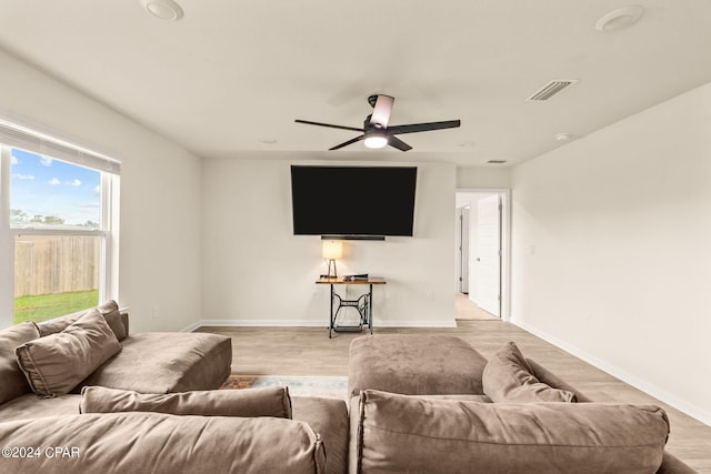 living room with ceiling fan and light wood-type flooring