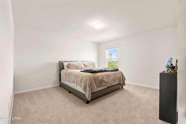 bedroom featuring light carpet