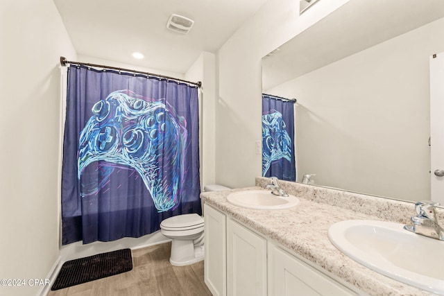 bathroom with a shower with curtain, hardwood / wood-style flooring, vanity, and toilet