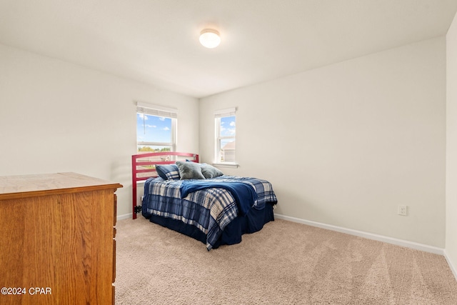 bedroom featuring light colored carpet