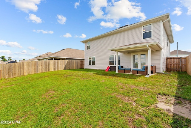 rear view of house featuring a yard and a patio area