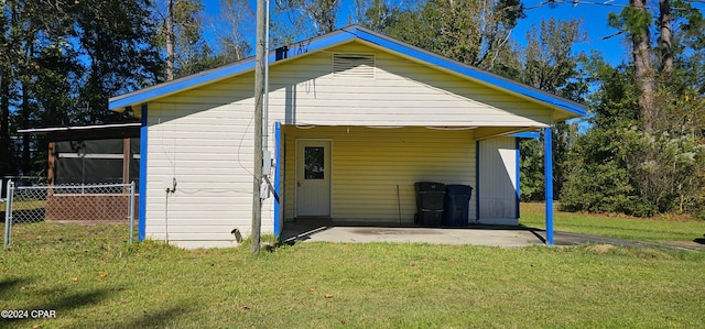 rear view of property featuring a patio area and a lawn