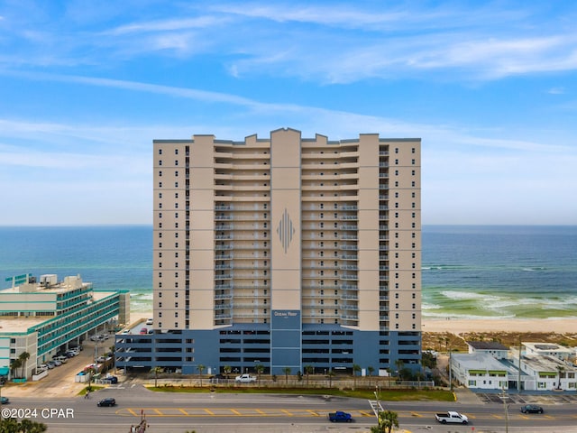 view of property featuring a beach view and a water view