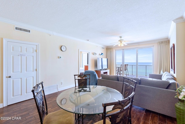 dining area with a textured ceiling, ceiling fan, dark hardwood / wood-style floors, and crown molding