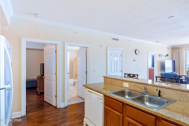 kitchen featuring white appliances, dark hardwood / wood-style flooring, a textured ceiling, crown molding, and sink