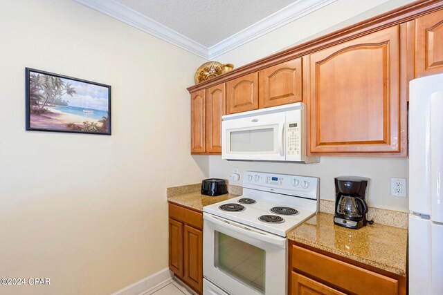 kitchen featuring ornamental molding, white appliances, a textured ceiling, and light stone counters