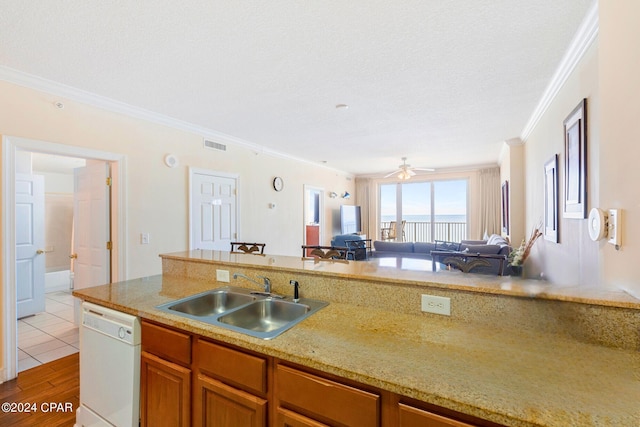 kitchen with light wood-type flooring, dishwasher, sink, ornamental molding, and ceiling fan