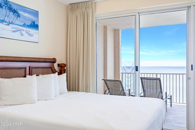 carpeted bedroom with a water view