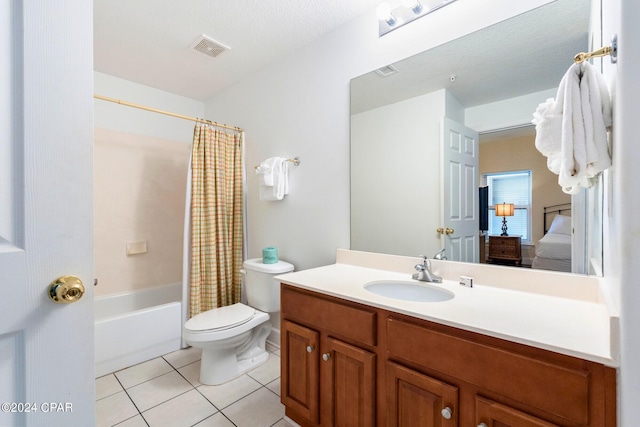 full bathroom featuring tile patterned flooring, shower / bath combo, a textured ceiling, vanity, and toilet