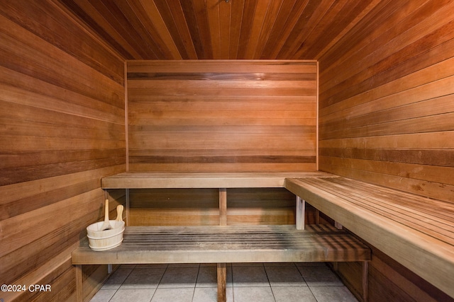 view of sauna with wood ceiling, wood walls, and tile patterned floors