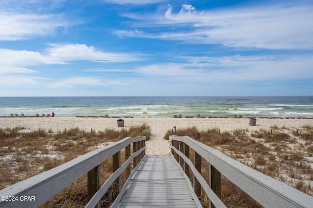 exterior space featuring a water view and a beach view