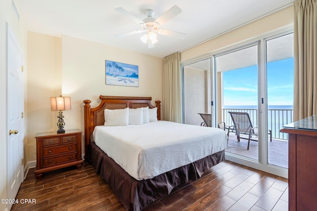 bedroom with ceiling fan, a water view, access to exterior, and dark hardwood / wood-style flooring