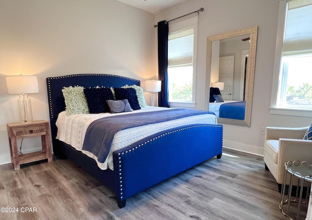 bedroom featuring wood-type flooring and multiple windows