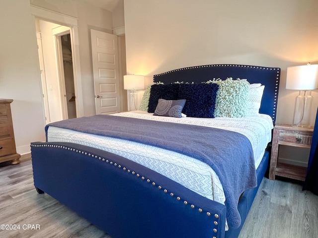 bedroom featuring baseboards and wood finished floors