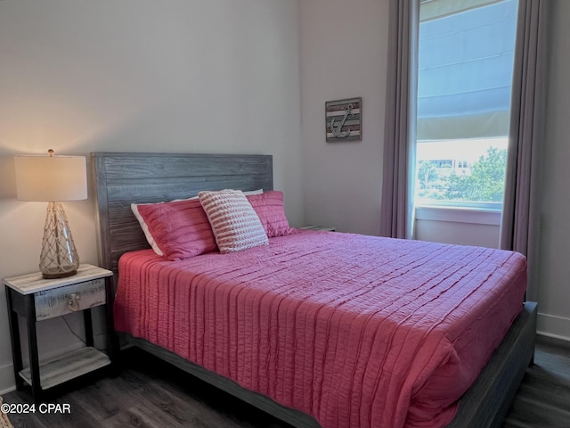 bedroom with dark wood-type flooring