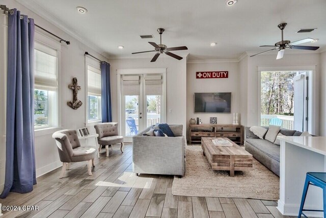 living room with ceiling fan, french doors, and plenty of natural light