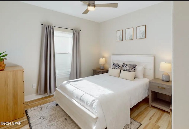 bedroom with light hardwood / wood-style floors and ceiling fan